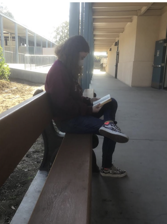 Aspen Newhouse (10) reads peacefully on a bench by the engineering building before
school. Aspen is a passionate reader, ardent escapist and individualistic artist. She got interested in reading through the
Percy Jackson series, enjoying fantasy books with complex plot structures and world building. Her intrigue in drawing
began with her friends  seeing talent, getting inspired, and working up to having her own personal art style.
I wanted to be like that, even though like my art skills werent like all that great because of my dysgraphia, Aspen said.
Photo and caption by Aria Bonski Evans.