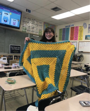Lila made this blanket for her older sister, Tara, who is a student at UCLA (hence the utilization of the school colors: blue and gold). It is crocheted in a granny square-style pattern.