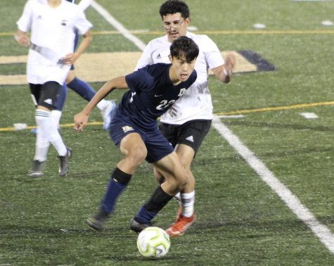 Ethan Foong (12) fights for a loose ball against Carpinteria High School