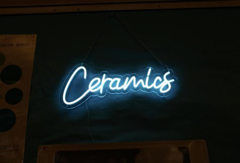 The neon “Ceramics” sign on the wall of their classroom.