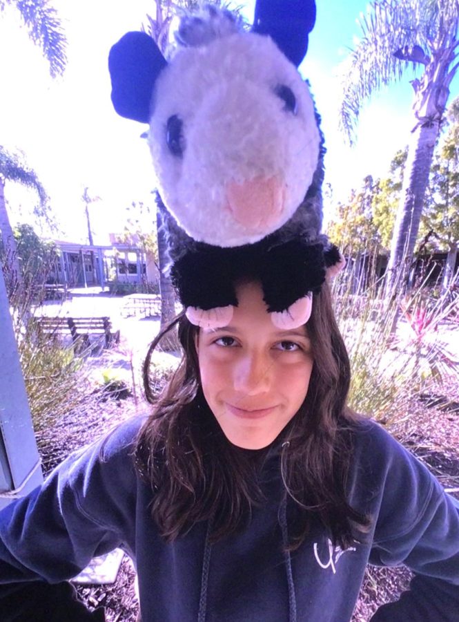 Carly with a stuffed possum on her head
