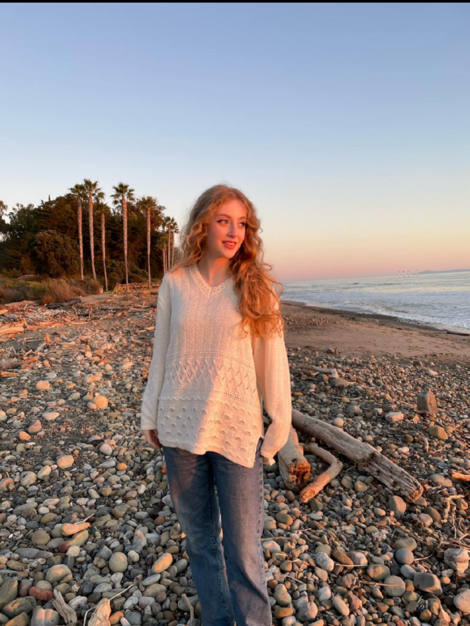 Senior Rachel Lenchner standing on a beach at sunset.