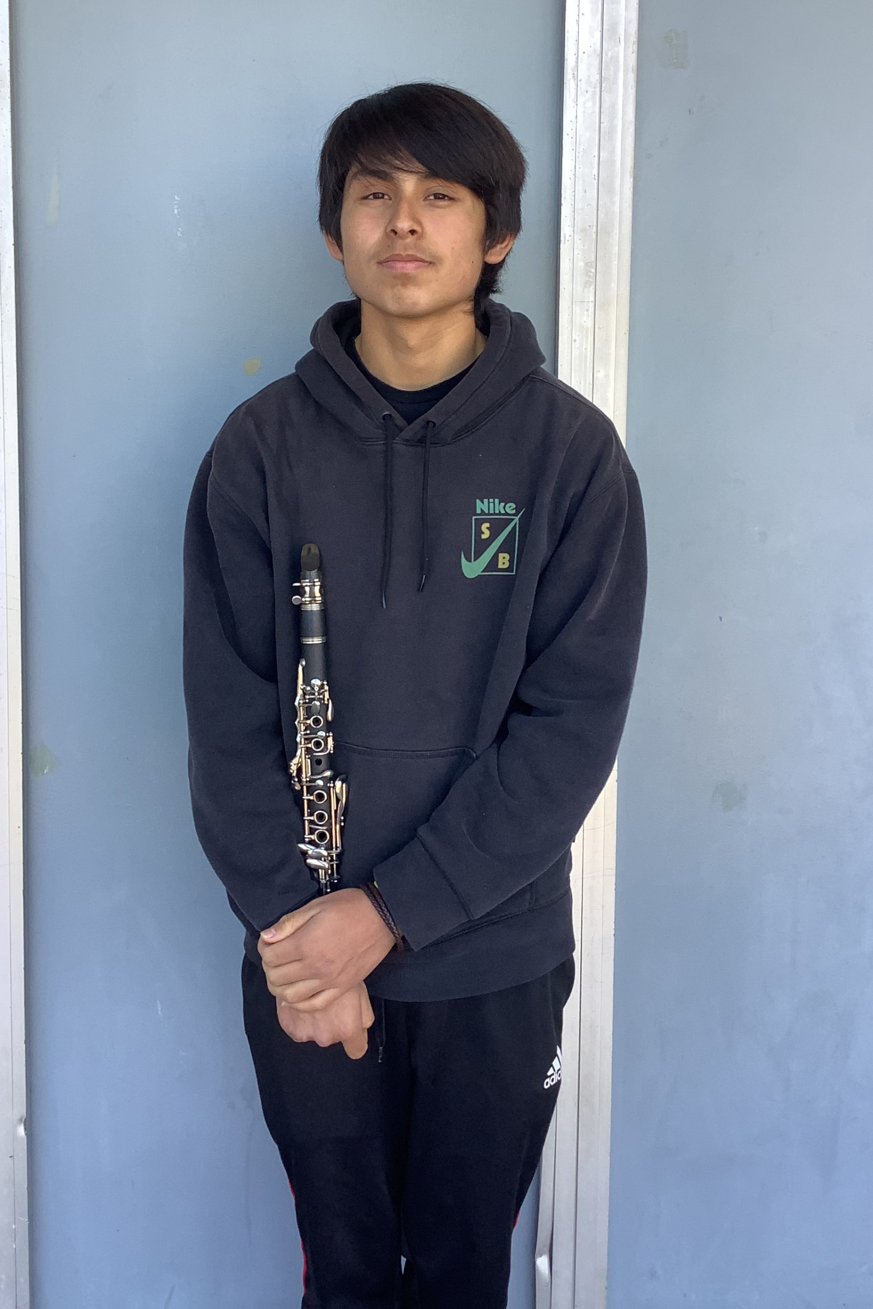 Sophomore Joseph Martinez shows his passion for music as he holds his clarinet.