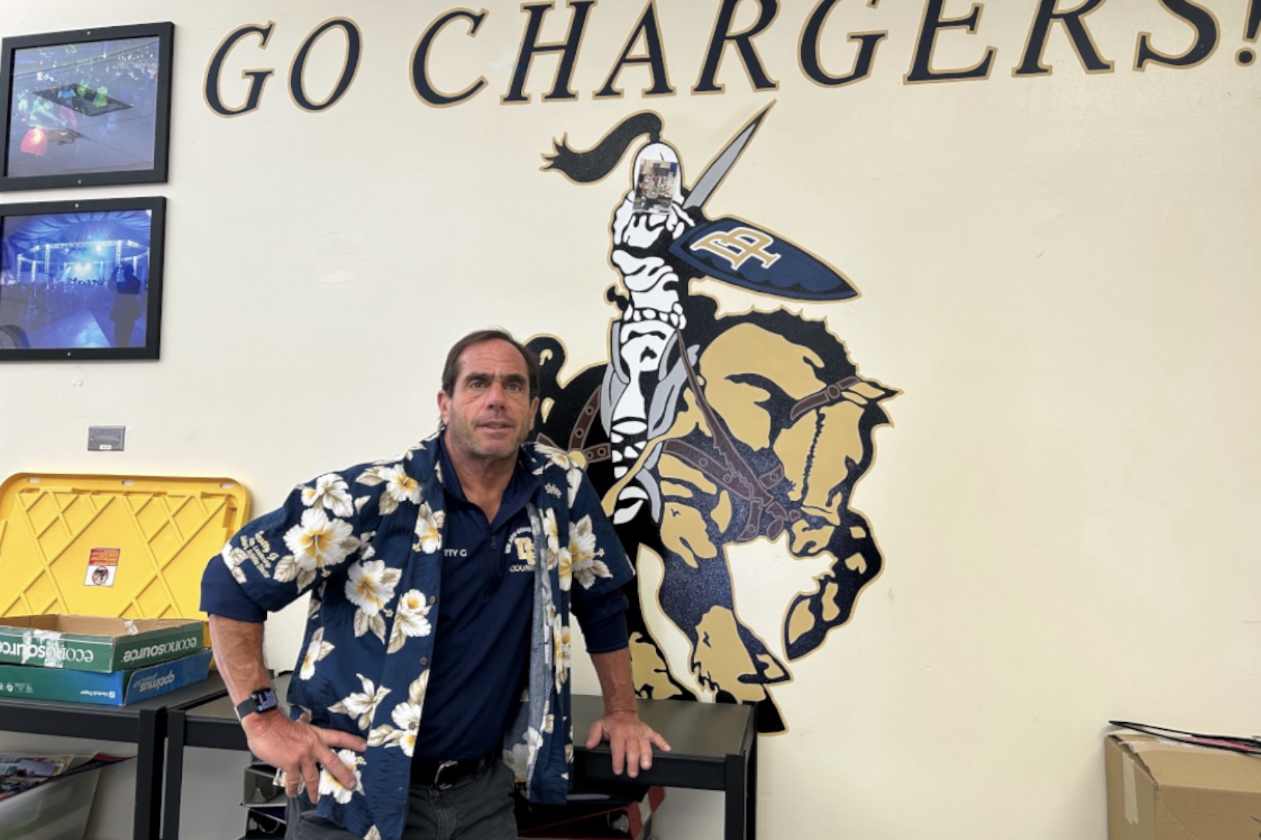 Scott Guttentag stands in front of a DPHS mural.