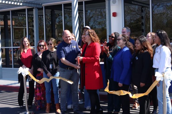 John Dent and Hilda Maldonado cut a ribbon signifying the opening of the new Media Building.