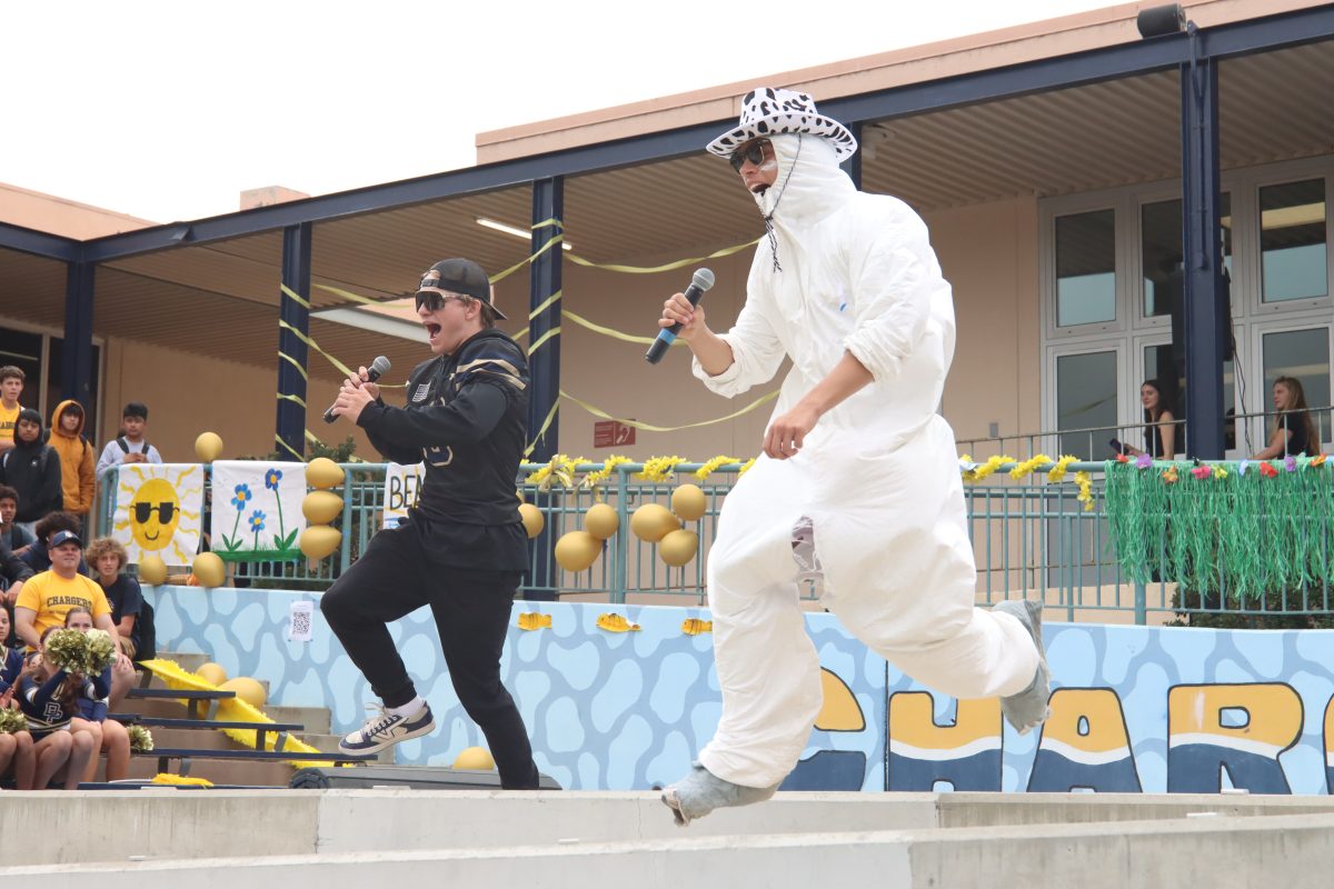 Zach Gesswein (12) and Gus Miller (12) hype up the crowd during the pep rally.