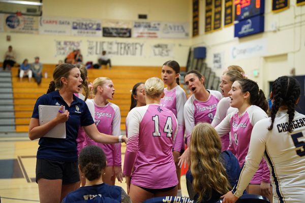 After the first set, Coach Megan O'Carroll gives a speech to the team and they cheer before the next set.