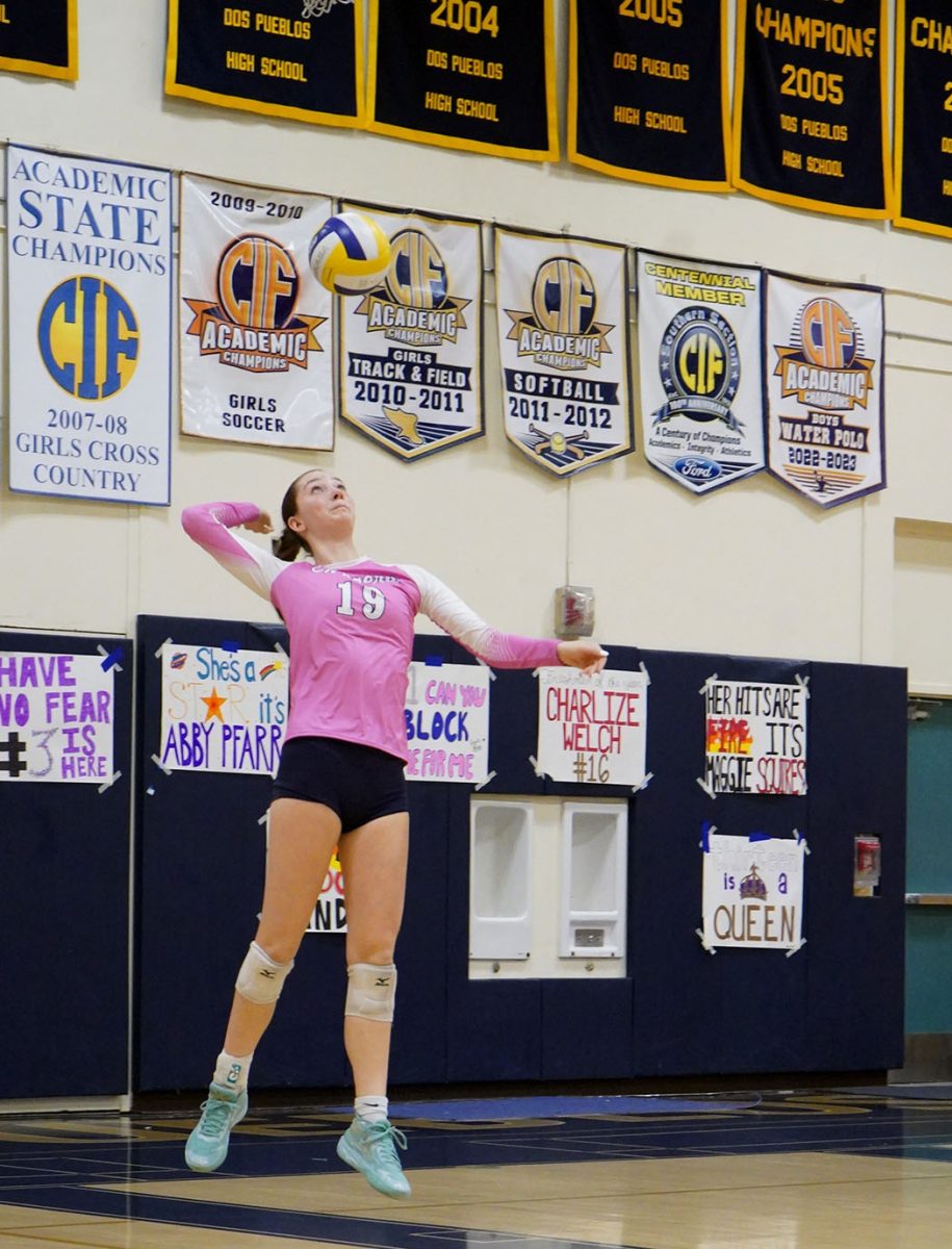 Setter and captain Halle Rillie (12) jumps up and serves the ball against Buena. Rillie had 23 assists, four aces, and 11 digs by the end of the third set.