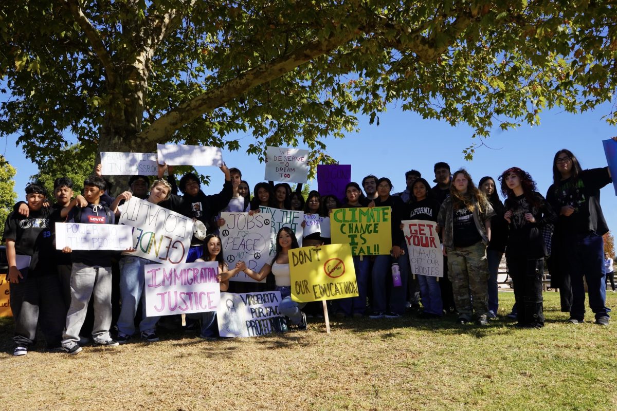 Students stand together holding signs in Evergreen Park.