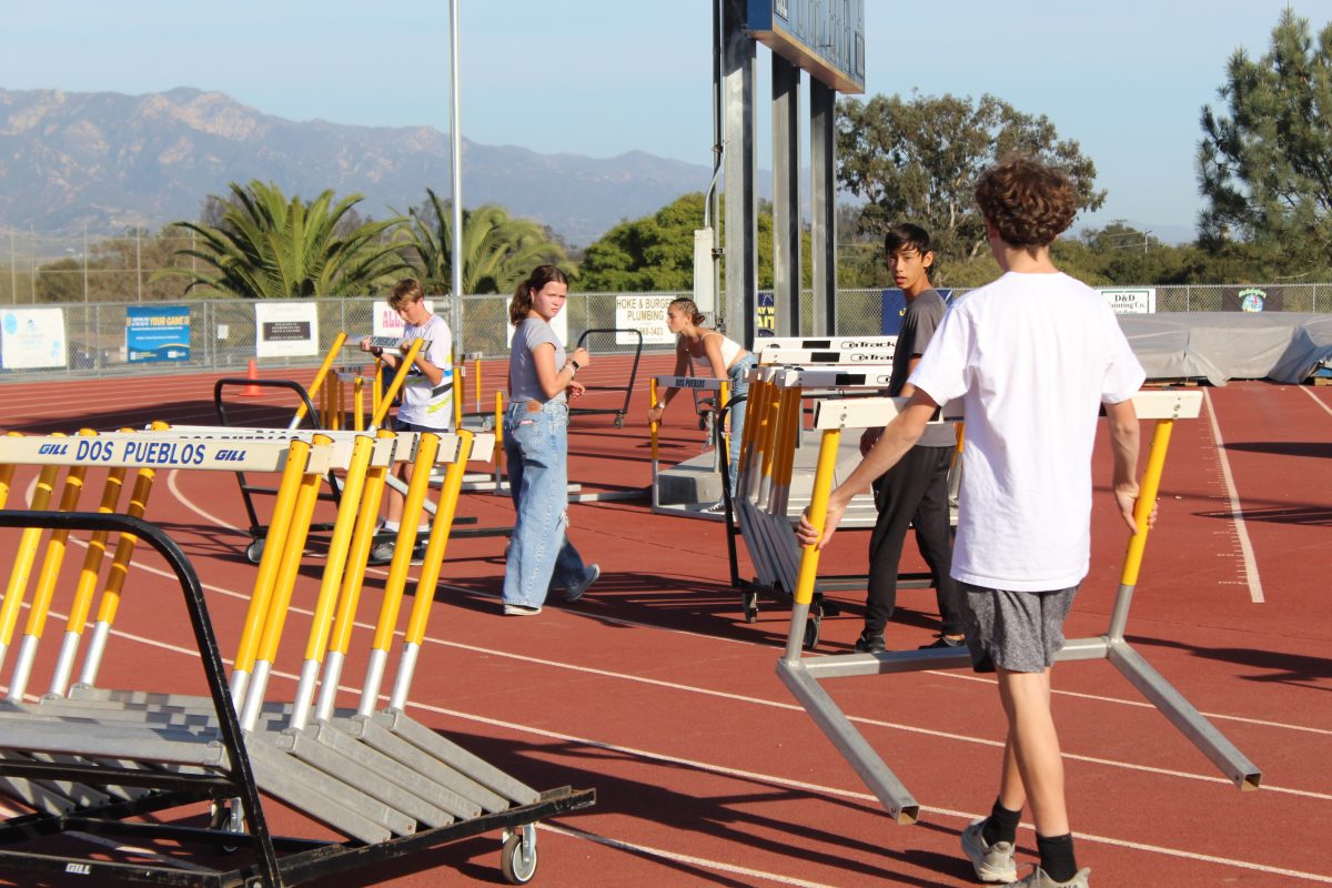 Students helping clean up equipment after cancellation of cross country meet.