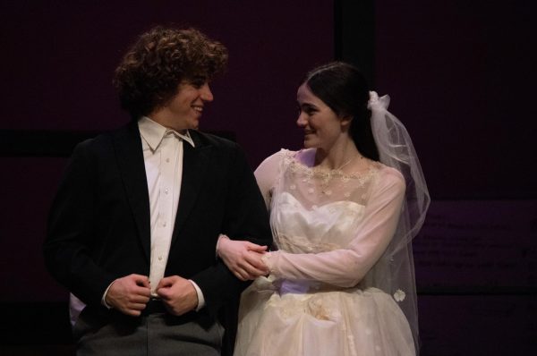 Andrew Cooper (10) and Nicola Bailey (11) smile at each other while leaving the altar.