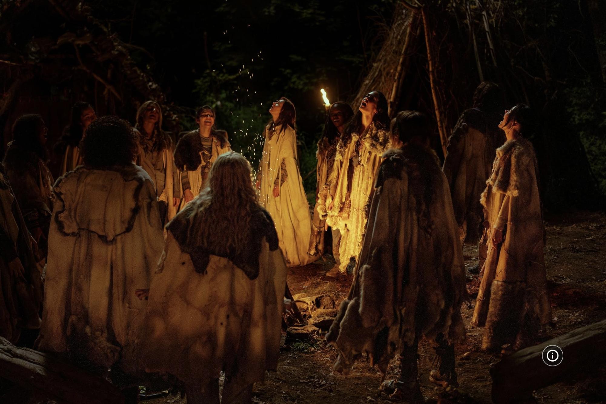 The team sings and circles their fire in a cannibalistic ritual.