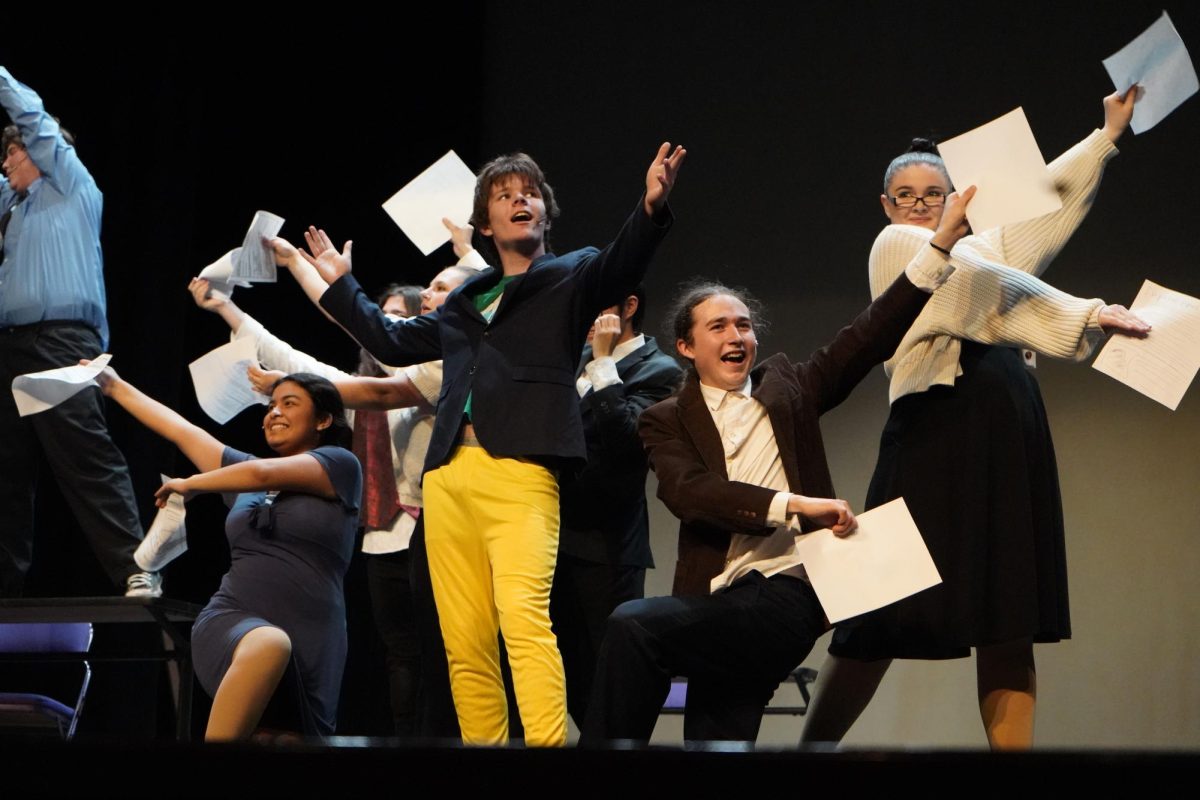 David Beck (10) as Buddy the Elf is surrounded by papers held by other cast members.