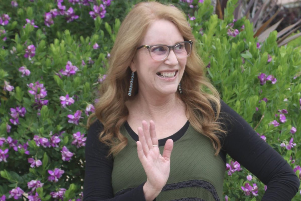 Magner waves to an off-camera student