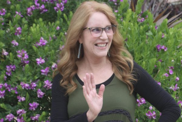Magner waves to an off-camera student