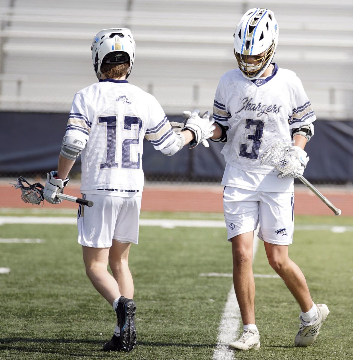 Senior Parker Bentley and sophomore Koa Birchim high fiving during a game.