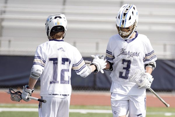 Senior Parker Bentley and sophomore Koa Birchim high fiving during a game.
