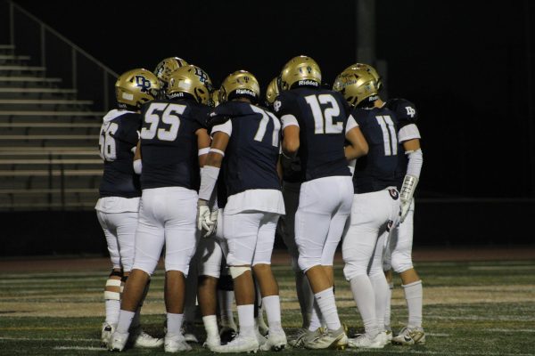 The Chargers offense huddling before making their next play.