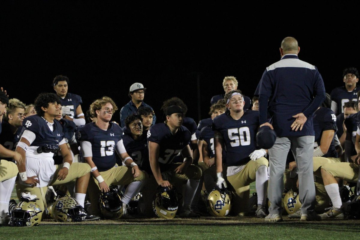 Coach Alexandros Pateras talks to the team after the game