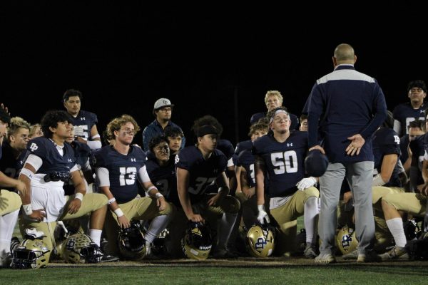 Coach Alexandros Pateras talks to the team after the game
