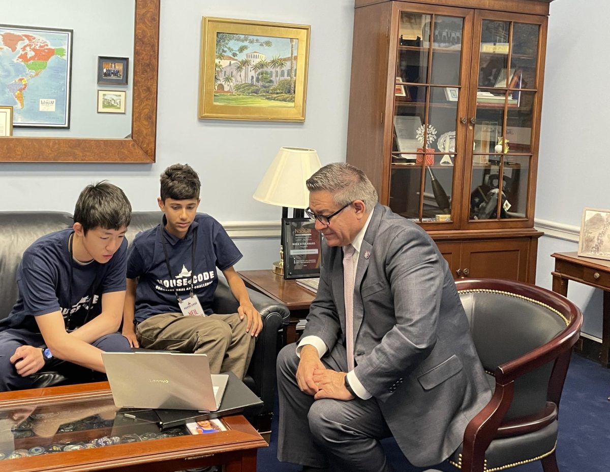 Ethan Ding (11) and Neil Sharangpani (11) showcasing their EuLearn app at The House of Code 