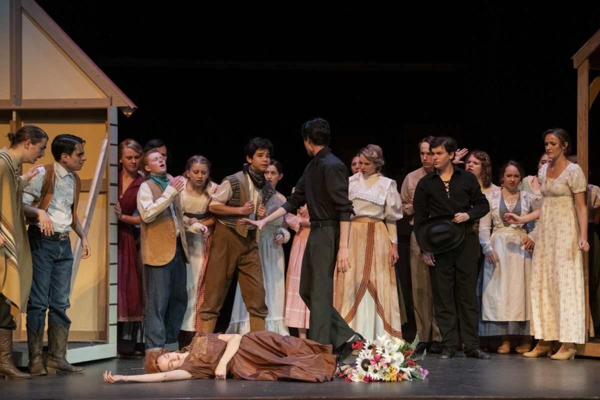 “Curtains” actors surround Nicollette Pfiefer (10) during her death scene.